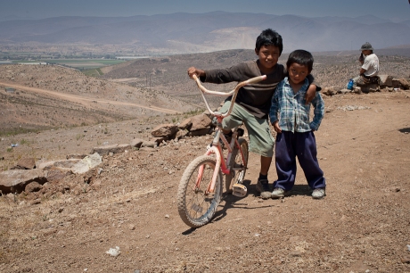 Kids with a bike. Mexico. 2006.